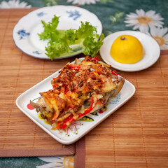 A Baked Pudding made with Potato, Sweet Bell Red Pepper, Chicken, Cheese and Tomato on Kitchen Table. Selective Focus.