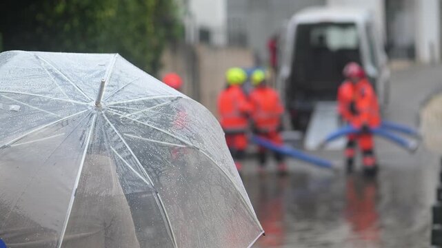Firemen and police on location in the historic centre of Cascais, Portugal following heavy rains and flooding from storm Leonardo