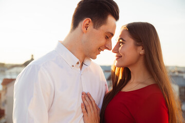 Fototapeta premium Couple enjoying a sunset together while standing close in a city setting