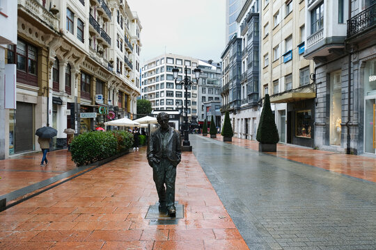 Oviedo, Spain - May 11, 2025. Woody Allen Statue, a life-size bronze sculpture by Spanish artist Vicente Santarua, located on Calle Milicias Nacionales, a central shopping street in Oviedo, Asturias.