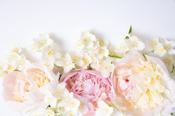Elegant floral background with peonies and jasmine on white surface, pastel colors, soft natural light, copy space, romantic spring composition for wedding invitations, greeting cards, branding