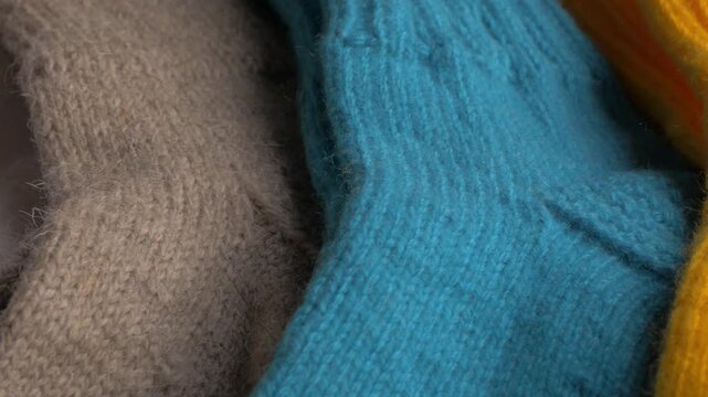 Colorful knitted socks in a close-up view, showcasing textures and patterns in a vibrant arrangement of fibers and hues. Knitted socks concept