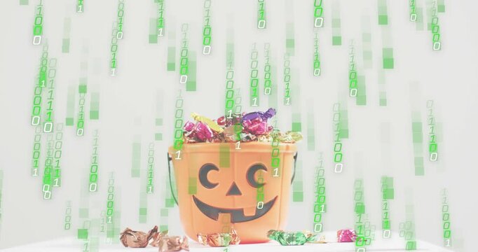 Binary streams starting at top cascading over pumpkin bucket holding candies, showing digital rain