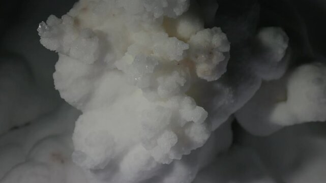 Close-up of natural salt formations inside a salt cave, showing mineral textures and crystalline surfaces. Geological detail of underground environment and natural deposits.