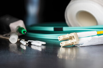 Fiber optic patch cords with accessories and tools for cleaning fiber optic connectors. Equipment used in telecommunications, network maintenance, and data transmission systems.