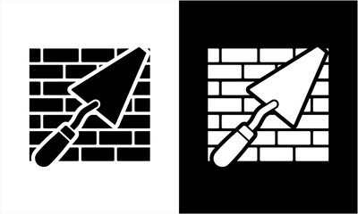Trowel and brick wall construction icon in black and white.