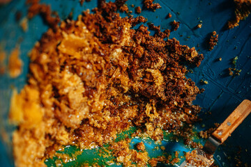Fototapeta premium Gathering honey from honeycomb in an apiary