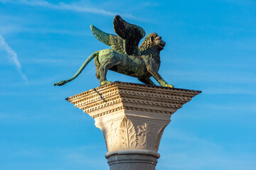 Winged lion sculpture (symbol of Venice) on San Marco column at St. Mark's square, Venice, Italy © Mistervlad