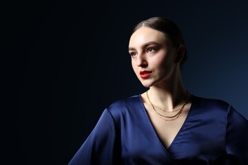 Fototapeta premium Portrait of beautiful woman on blue background