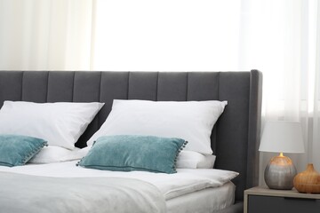 Fototapeta premium Comfortable bed with clean linens in bedroom