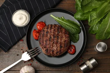 Fotobehang Eten Delicious grilled meat patty, tomatoes and spinach on wooden table, flat lay  © New Africa