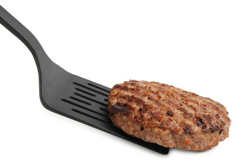 Naklejka premium Spatula with delicious grilled meat patty isolated on white