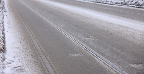 Tire tracks on snowy road outdoors, closeup