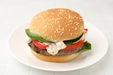 Fotobehang Eten Delicious burger with meat patty on white tiled table, closeup  © New Africa