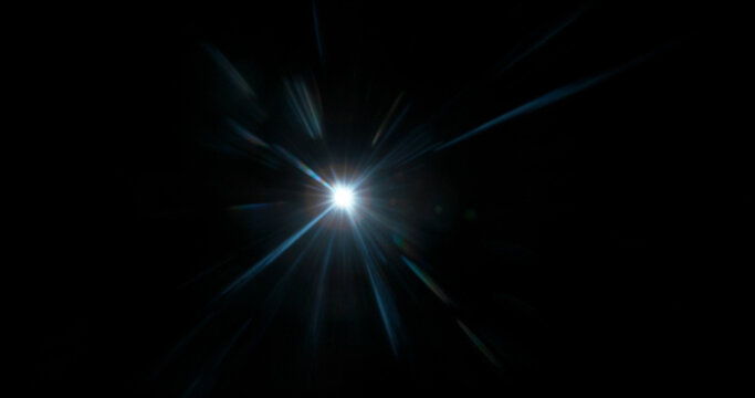 Abstract cinematic lens flare with bright light burst and star rays, isolated on black background. Optical light effect ideal for VFX overlays, transitions, titles and dramatic visual accents.