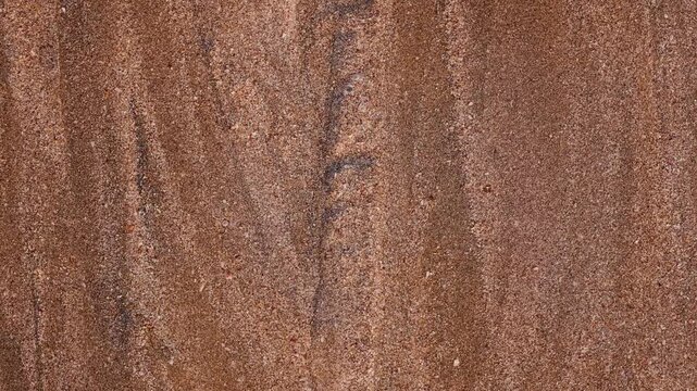 Magical with Black Sand Beaches on multicolored Hormuz Island, Iran. The dark sand from heavy minerals such as hematite, ilmenite, and magnetite, creating striking textures along the shoreline.