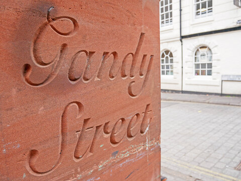 Gandy Street Name Etched Into Red Sandstone on the wall of a building in Exeter Old Town Shopping Street, Devon, England