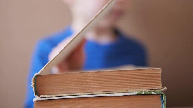Close-up of an old vintage book being opened by young child