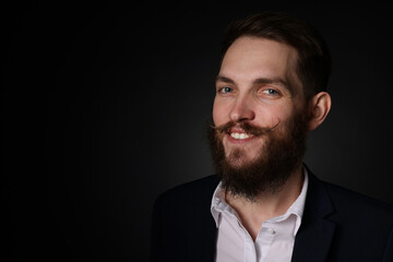 Man with stylish mustache and beard on black background. Space for text