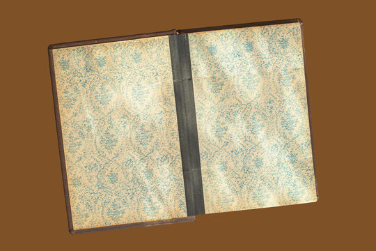 Open book endpapers in the suns rays with shadow. Open book with patterned endpapers, visible spine and binding, design layout, book texture mockup,natural background, copy space