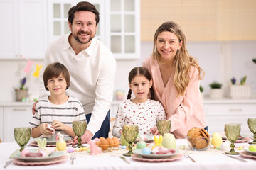 Easter celebration. Family at served table in kitchen