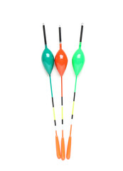 Colorful fishing floats isolated on white background, three bobbers for angling and tackle equipment, vertical studio shot with copy space © Pixel-Shot
