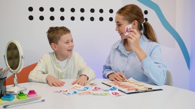 Speech therapist working on articulation with young boy