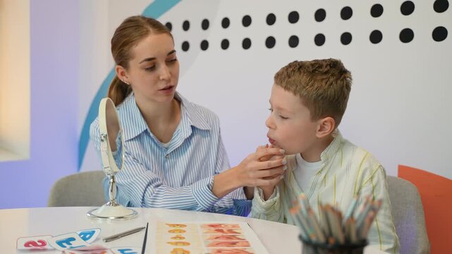 Speech therapist working with young boy pronunciation