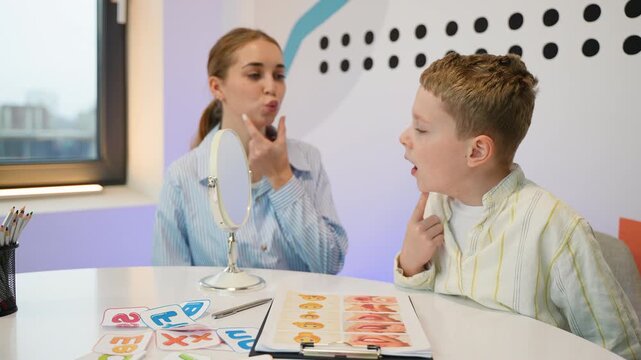 Speech therapist working on articulation with a young boy