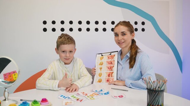 Speech therapist working with young boy in a clinical setting