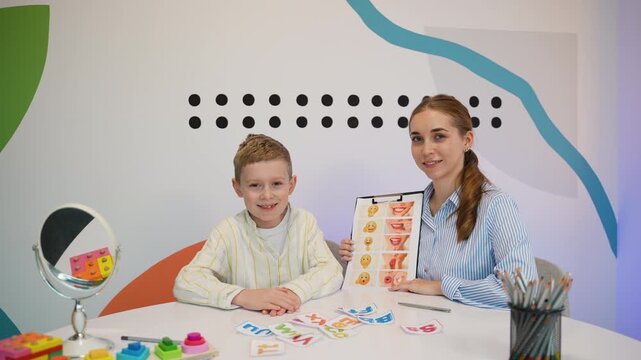 Speech therapist and young boy practicing articulation