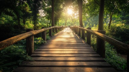 Obraz premium A wooden bridge leading through a lush forest, bathed in the golden light of the setting sun.