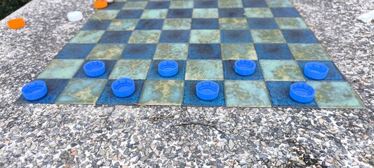 The checkers table is made of stone.
