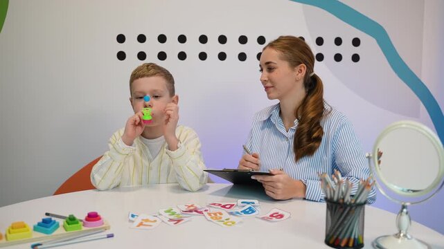 Speech therapist working with child on breathing exercises