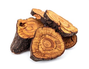 Close-up of sliced, dried wood pieces with visible annual rings against white background