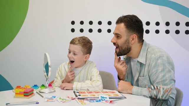 Speech therapist working with child on articulation