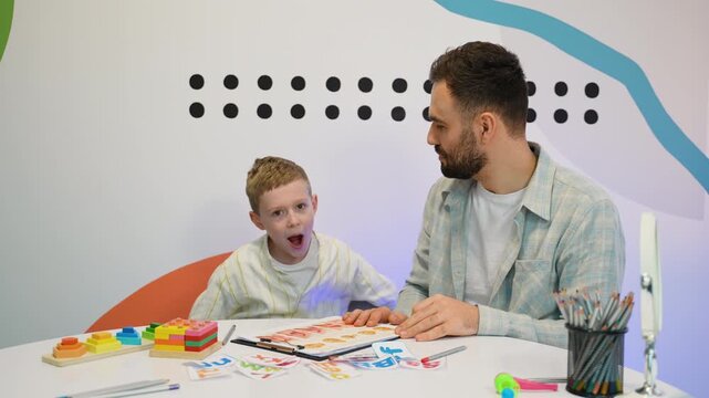Child speech therapist practicing sounds with boy