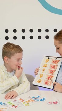 Speech therapist working with young boy pronunciation