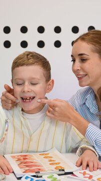 Speech therapist working on articulation with young boy