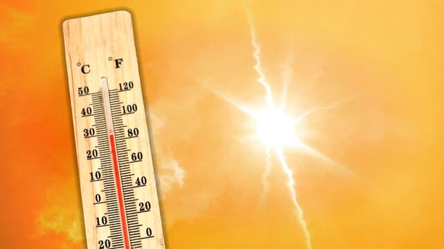 A thermometer showing a high temperature against an orange sky and a blazing sun. Heat wave concept. Extreme weather. The impact of global warming