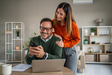 Couple enjoying technology at home for shared digital experience