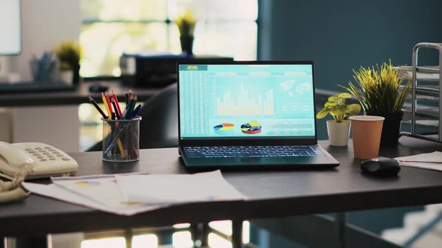 Laptop displaying financial data in modern office