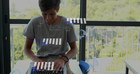 Typing teen wearing grey t-shirt and bracelets at desk by balcony windows, with laptop holograms