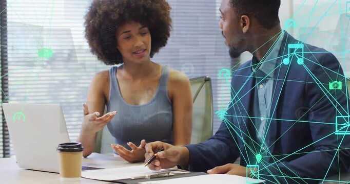 Woman pointing at laptop, reviewing biz docs while man leaning in, teal overlay showing laptop data