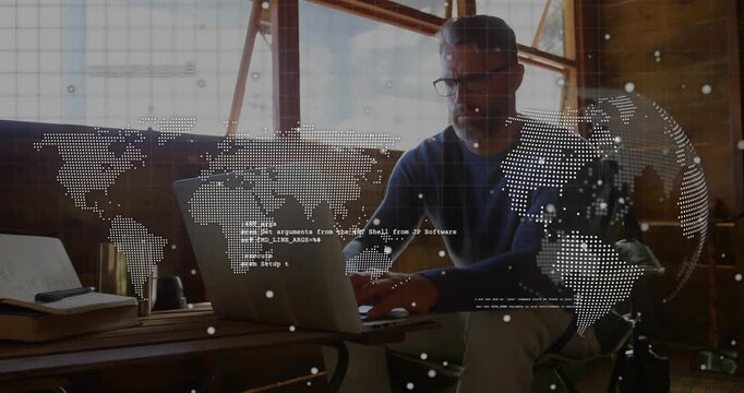 Software developer starting typing on laptop in loft, animated world map overlaying desk and code