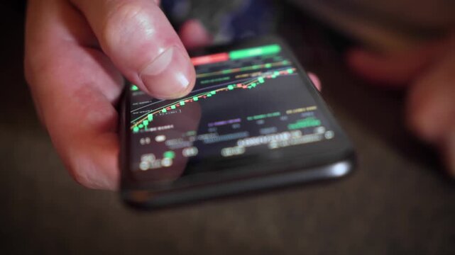 Person using smartphone to analyze cryptocurrency market data