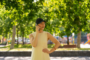 Woman talking on mobile phone in green park