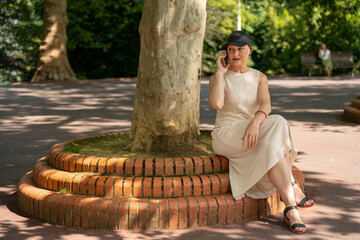 Mature woman enjoying outdoor phone conversation