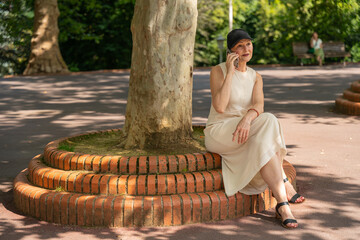 Woman talking on mobile phone in park