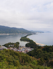 Fototapeta premium Amanohashidate, Miyazu, Japan, Kyoto Prefecture, landscape view, with Miyazu Bay, Tango Amanohashidate Oeyama Quasi-National Park, sandbar and beach during fall season, one day trip from Kyoto